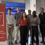 Group of seven people standing beside a Loneliness Taskforce Research Network banner at an ALONE event
